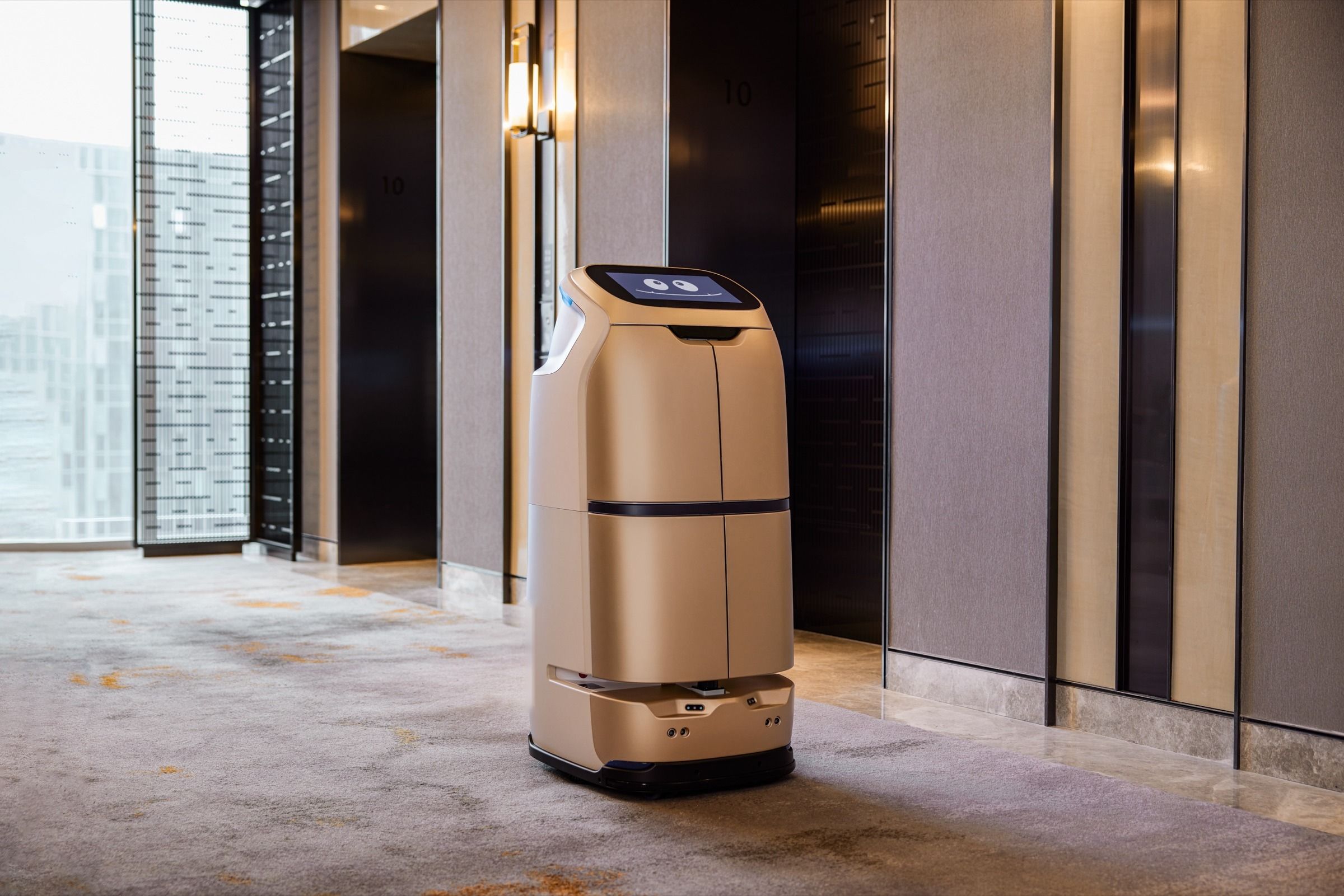 Enclosed delivery robot waiting in a hotel lift lobby