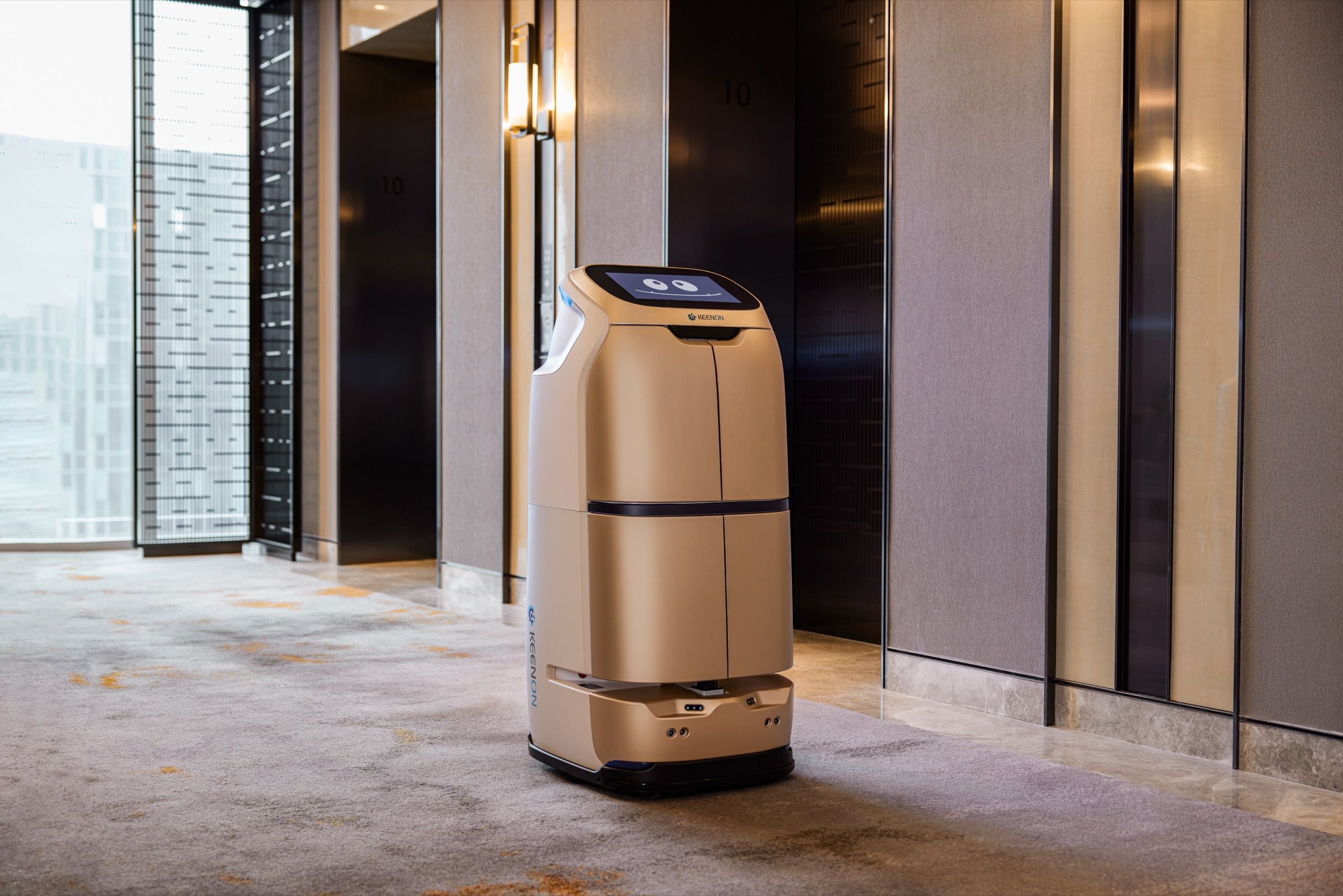 Enclosed delivery robot waiting in a hotel lift lobby